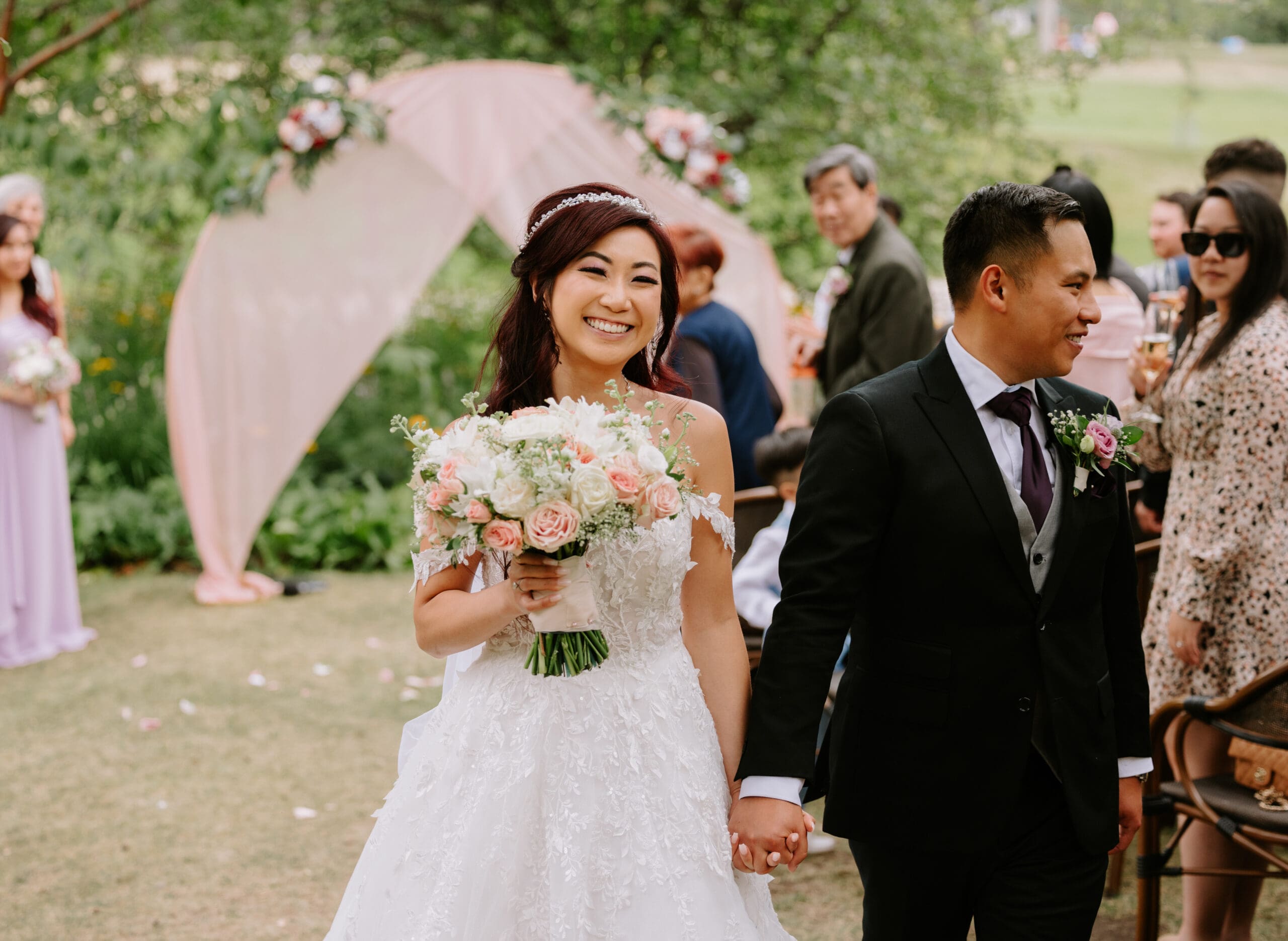 A couple walks back down the aisle after being married at the River Cafe in Calgary, Alberta