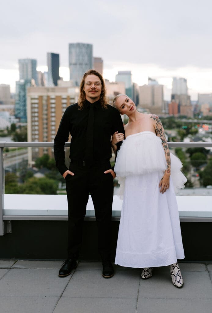 A couple poses for photos on a Calgary rooftop